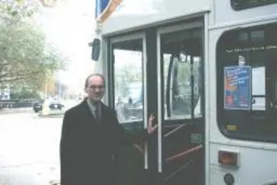 Michael Headley alongside a bus