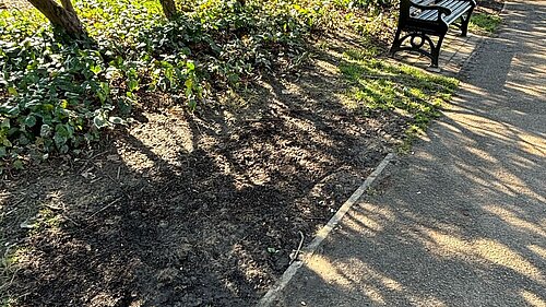 space where a bench once sat in Bedford Park