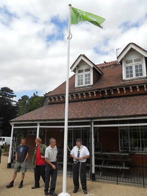 Dave Hodgson raising the Green Flag at the Award-Winning Bedford Park