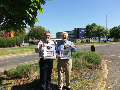 Mayor Dave Hodgson and Deputy Mayor Cllr Charles Royden with Average Speed Camera Signs on Polhill Avenue, Bedford