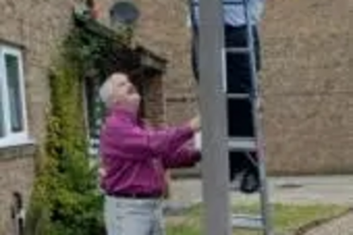 Dave Hodgson and Charles Royden putting up SmartWater signs on lampposts in Brickhill