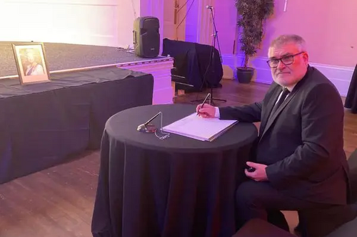 Mayor Dave Hodgson signs the Book of Condolence