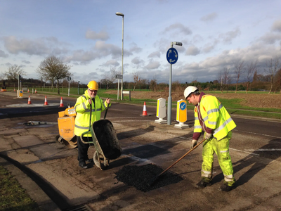 Dave Hodgson lends a hand on site during pothole repair work on Wentworth Drive in Bedford