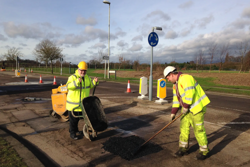 Dave Hodgson lends a hand on site during pothole repair work on Wentworth Drive in Bedford