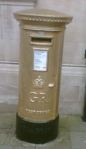 The gold postbox in St Paul's Square, Bedford, painted in honour of Etienne Stott's gold medal at the London 2012 Olympic Games