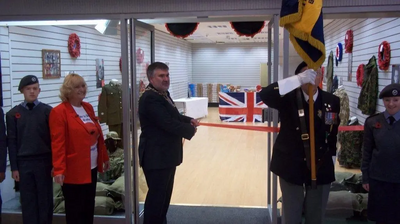 Dave Hodgson cuts the ribbon to mark the opening of Bedford's Poppy Shop