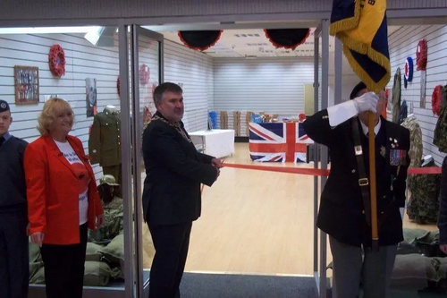 Dave Hodgson cuts the ribbon to mark the opening of Bedford's Poppy Shop